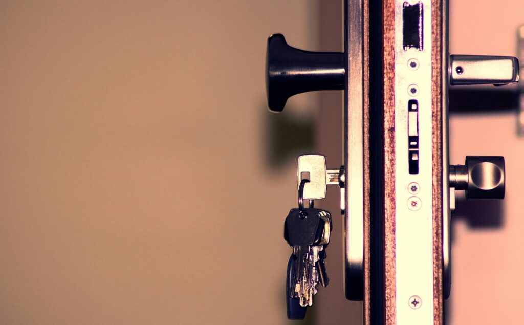 Keys inserted in a door lock showing home security and access control